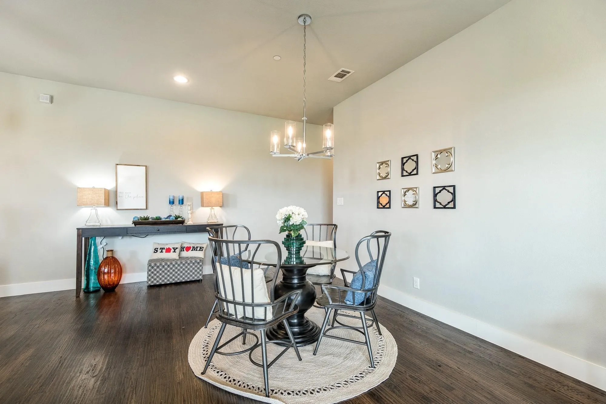 The property features hardwood floors, a modern chandelier, and recessed lighting