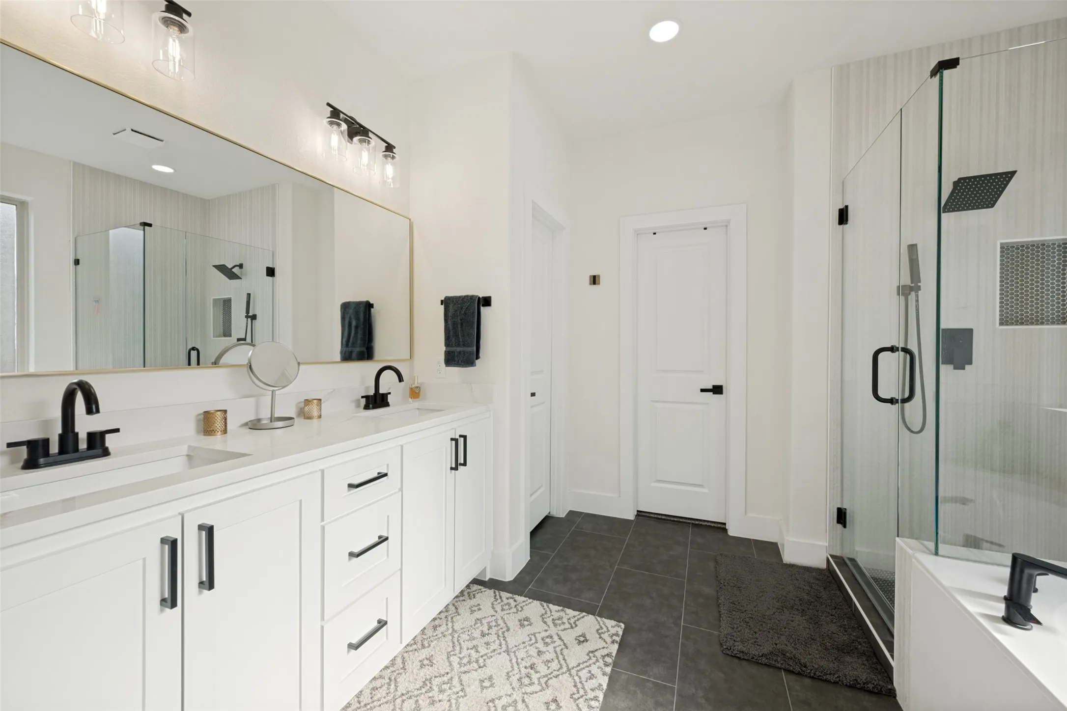 Dual vanity with white cabinetry, quartz countertops, and matte black fixtures
