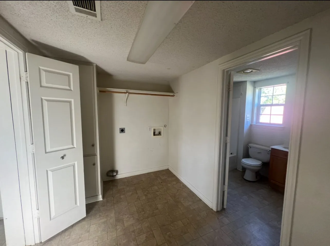 Dedicated laundry area featuring a wall-mounted drying rack and utility hookups