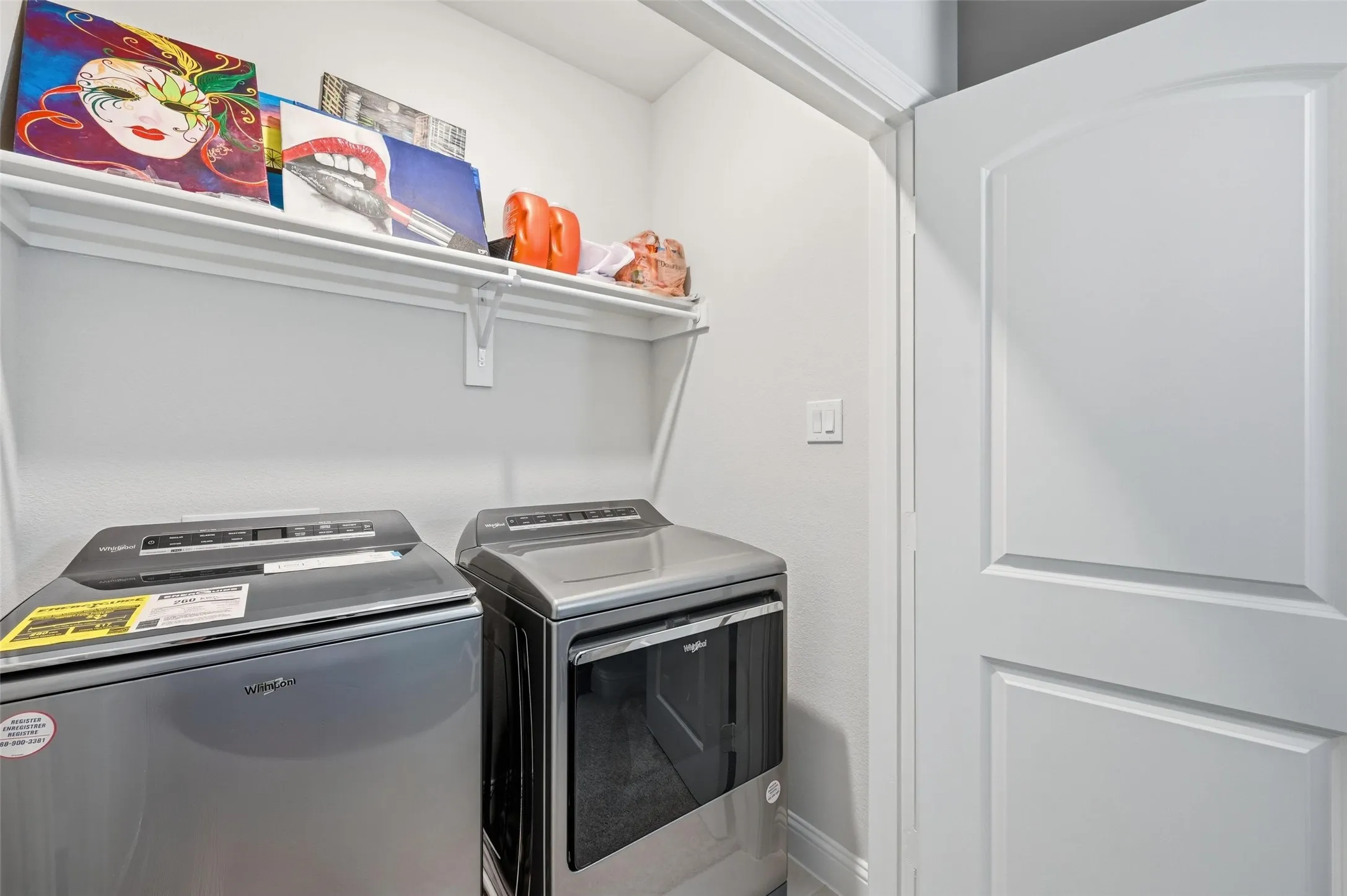 Laundry area with washer and dryer and baseboards