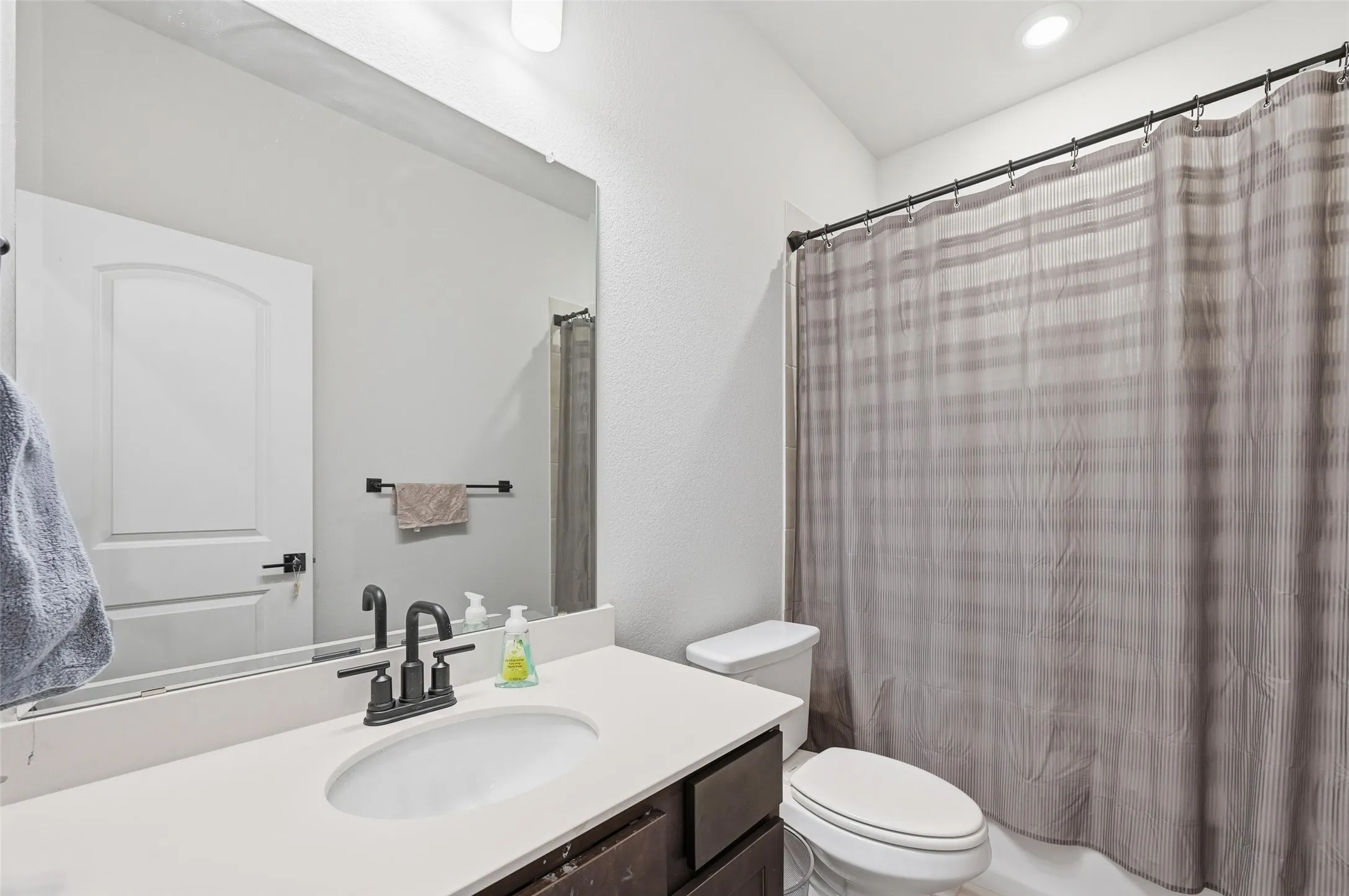 Full bathroom featuring vanity and shower / bathtub combination with curtain