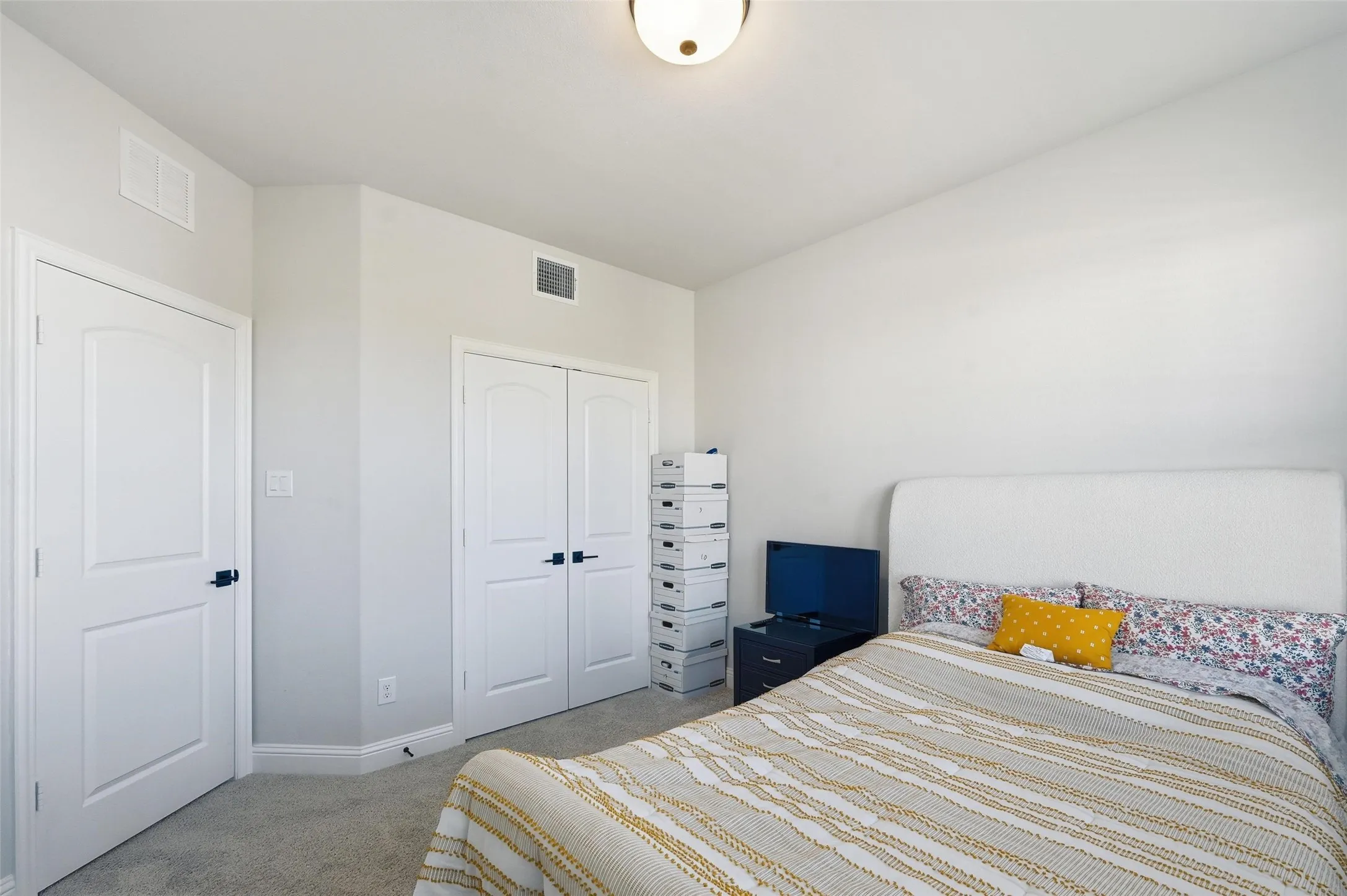 Carpeted bedroom featuring baseboards and a closet