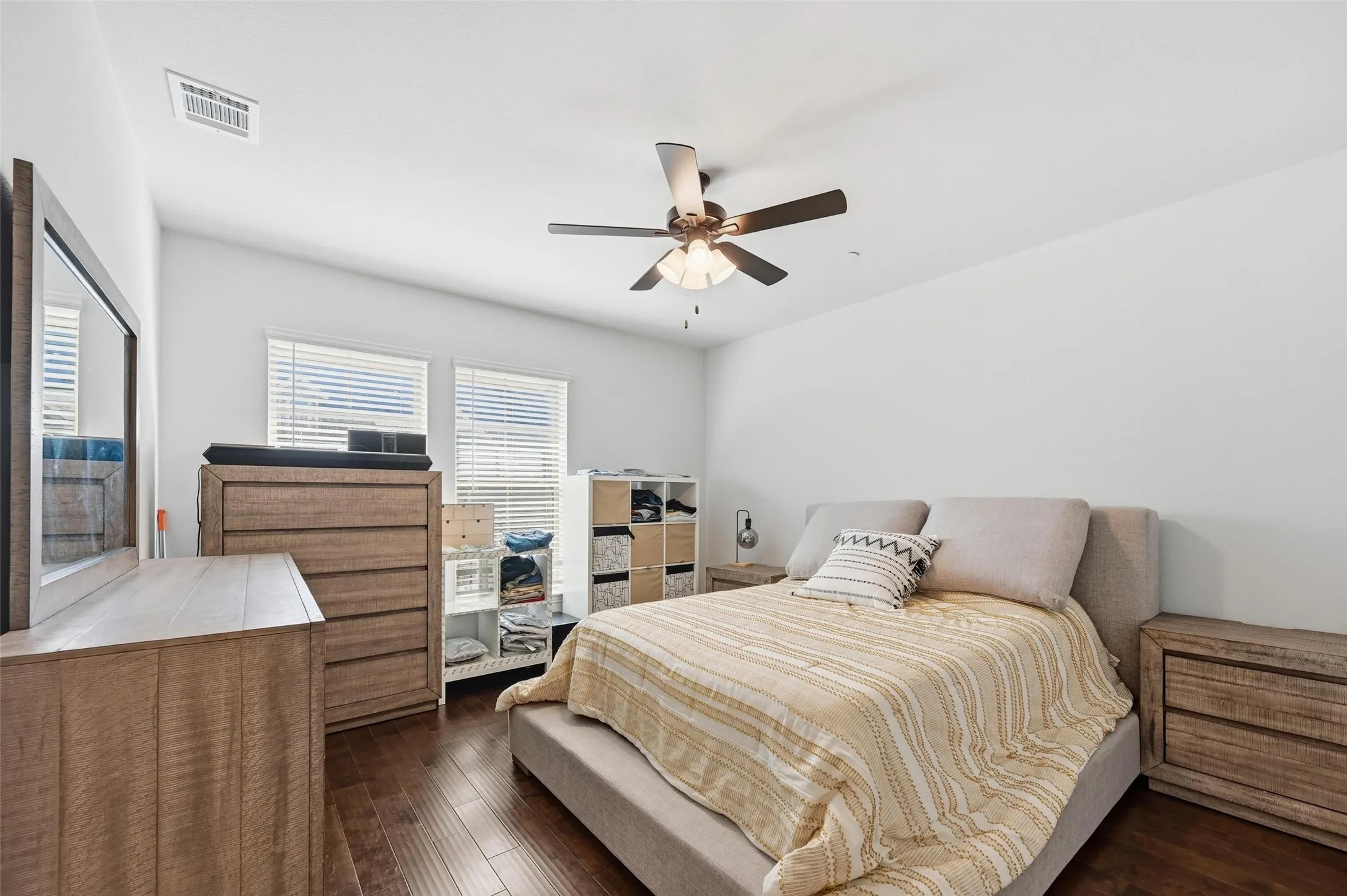 Bedroom with dark wood finished floors and ceiling fan