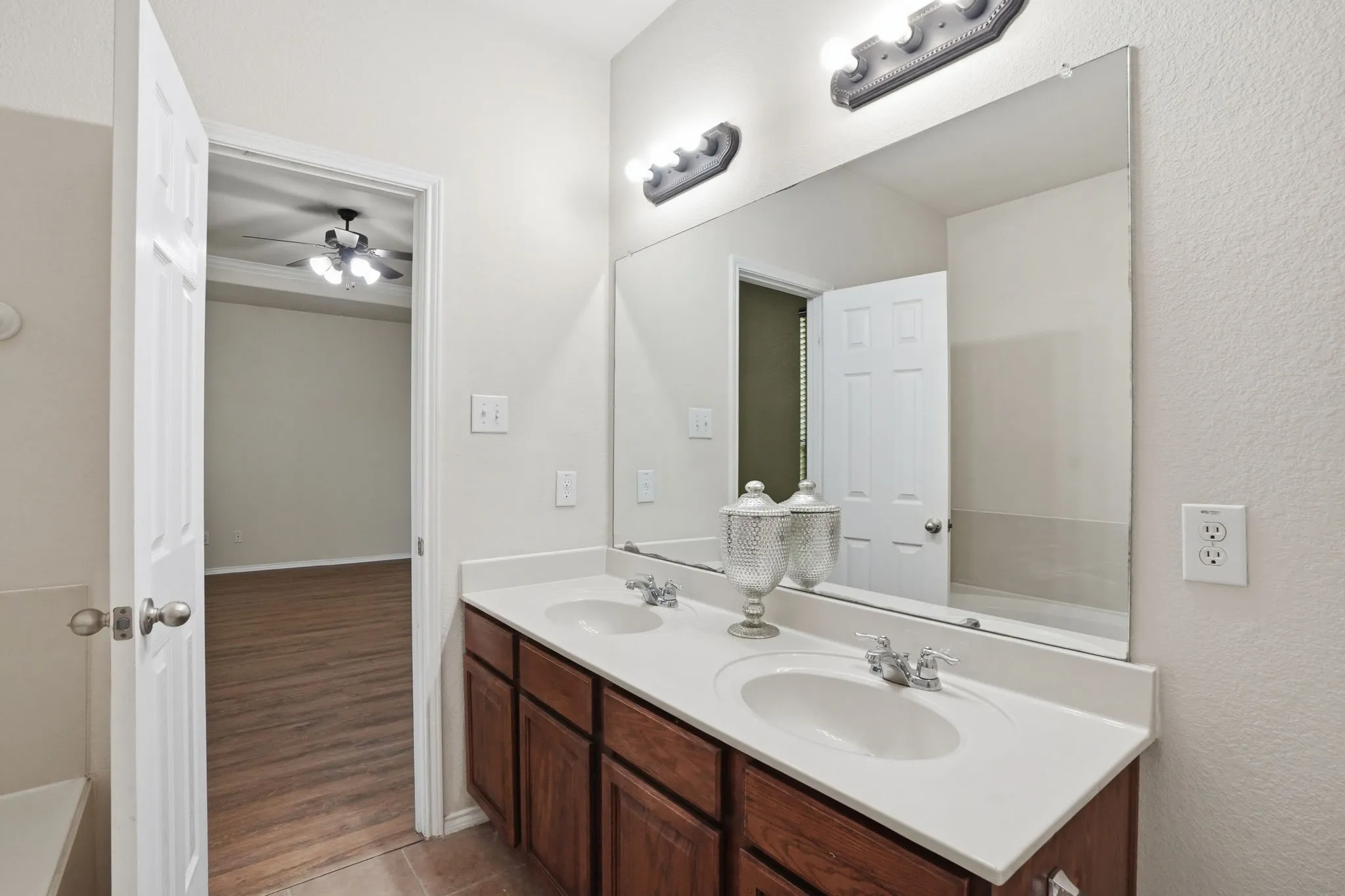Dual vanity featuring white oval undermount sinks and chrome fixtures