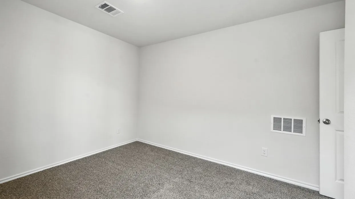 Room featuring light-colored walls, gray carpet, and white trim