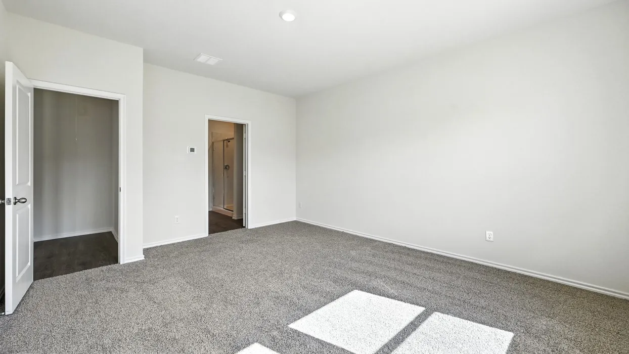 Spacious room featuring light gray carpet flooring and white painted walls
