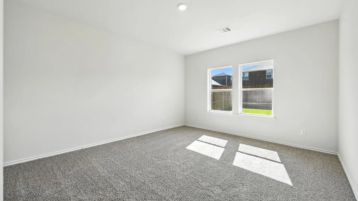 Room featuring two windows, neutral gray carpeting, white painted walls, and white trim