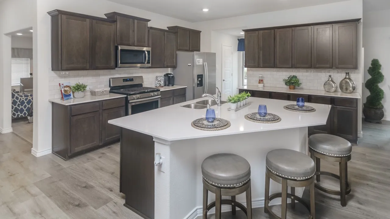 Kitchen featuring a central island with countertop seating, wood-finish flooring, dark wood cabinetry, white subway tile backsplash, and stainless steel appliances