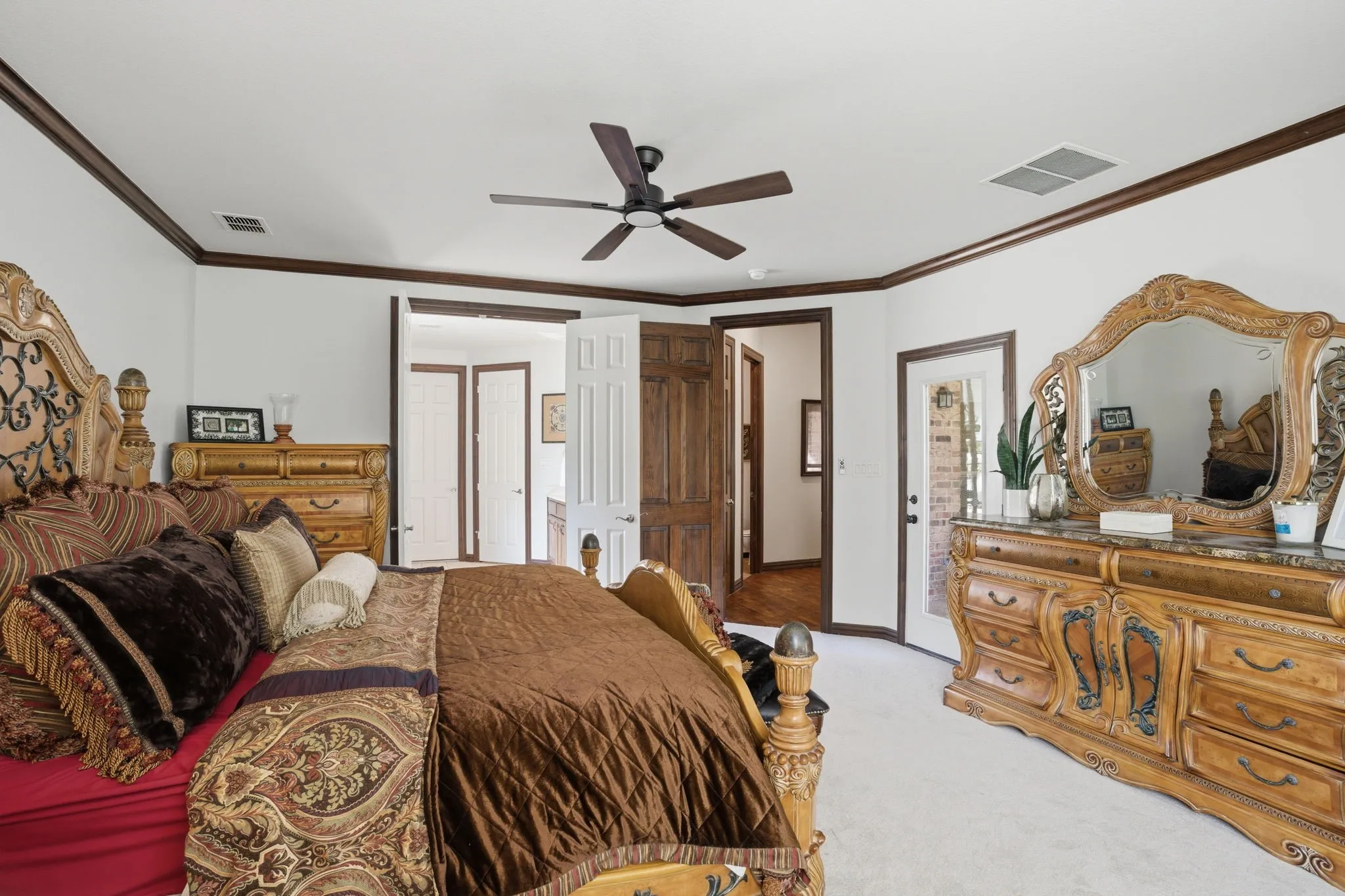 An exterior door provides private access to the back porch, while French doors open to the en-suite bathroom.
