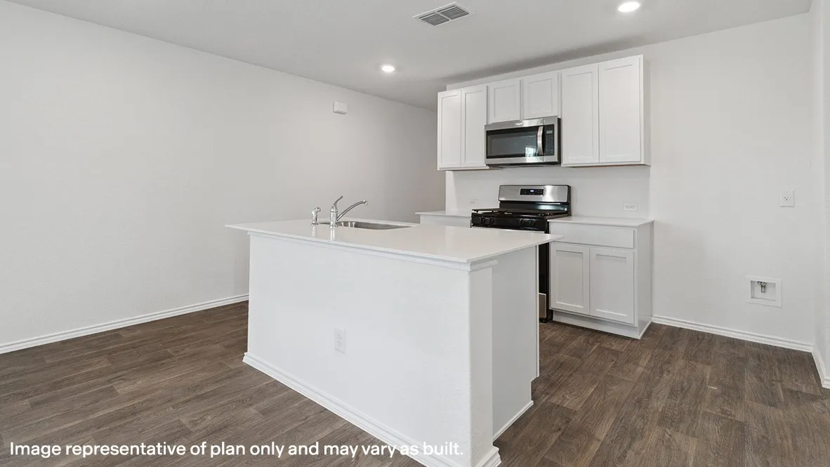 Kitchen featuring a central island with an integrated sink, white cabinetry, stainless steel appliances, wood-finish flooring, and recessed lighting