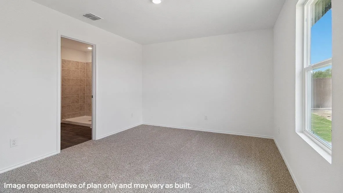 Spacious room with plush carpeting, neutral white walls, and a recessed ceiling light