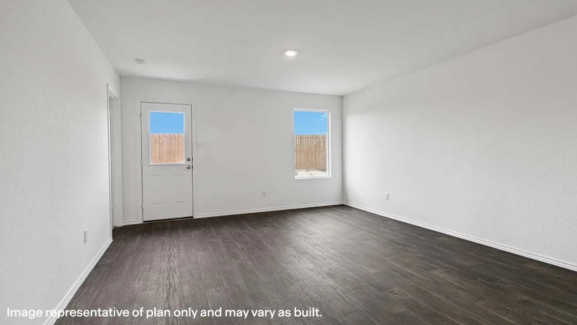Spacious room featuring dark wood-finish flooring, crisp white walls, and a recessed ceiling light