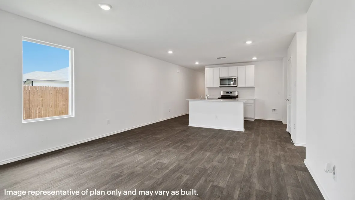 Open-concept living area featuring wood-finish flooring, recessed lighting, and a kitchen with white cabinetry, a kitchen island, and stainless steel appliances