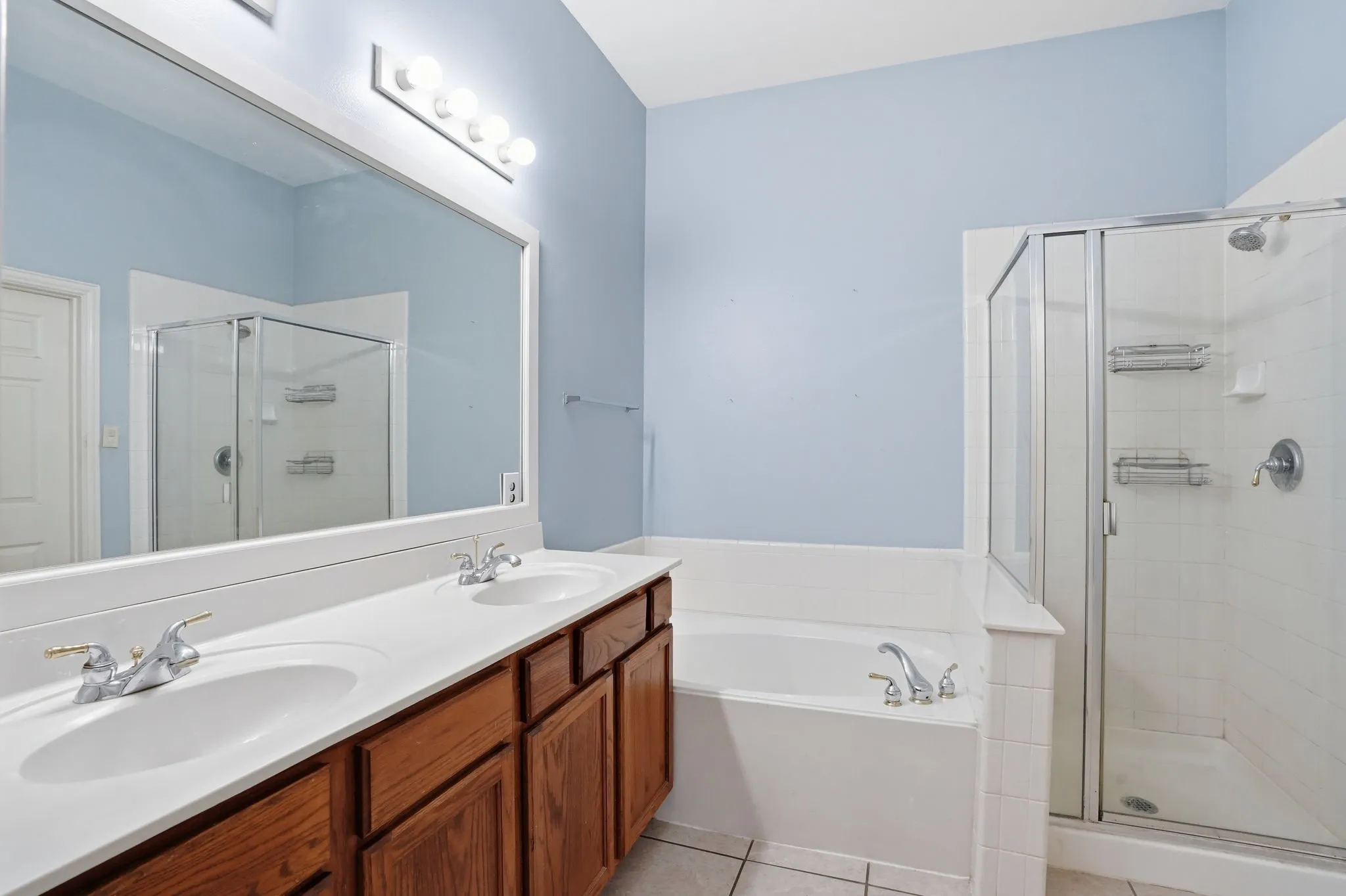 En-suite private bath with dual sinks, garden tub and separate shower