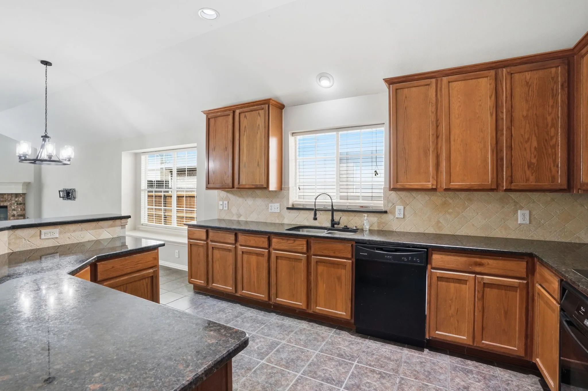 Roomy kitchen with wrap-around cabinets and countertops