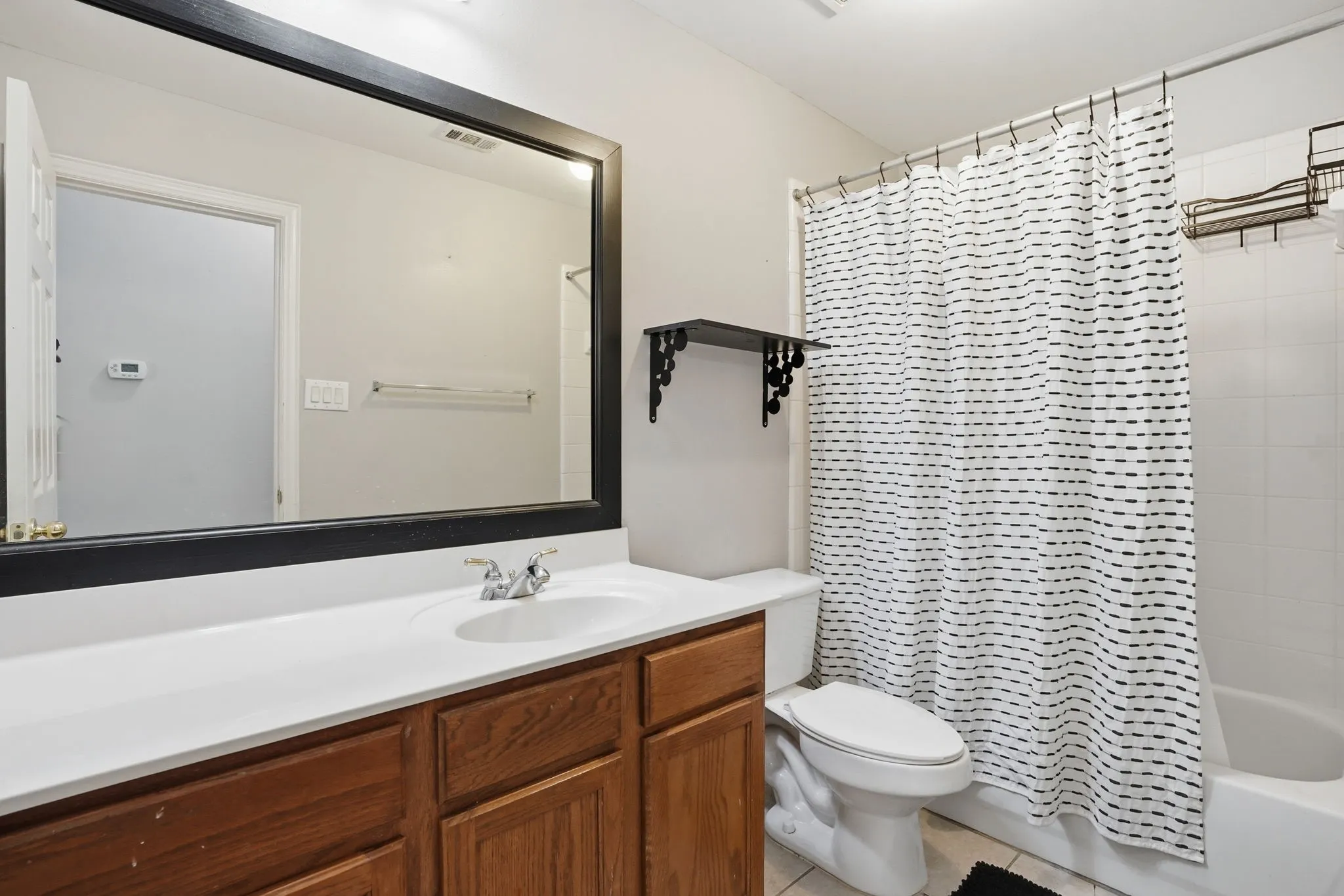 Secondary full bathroom including tub with shower