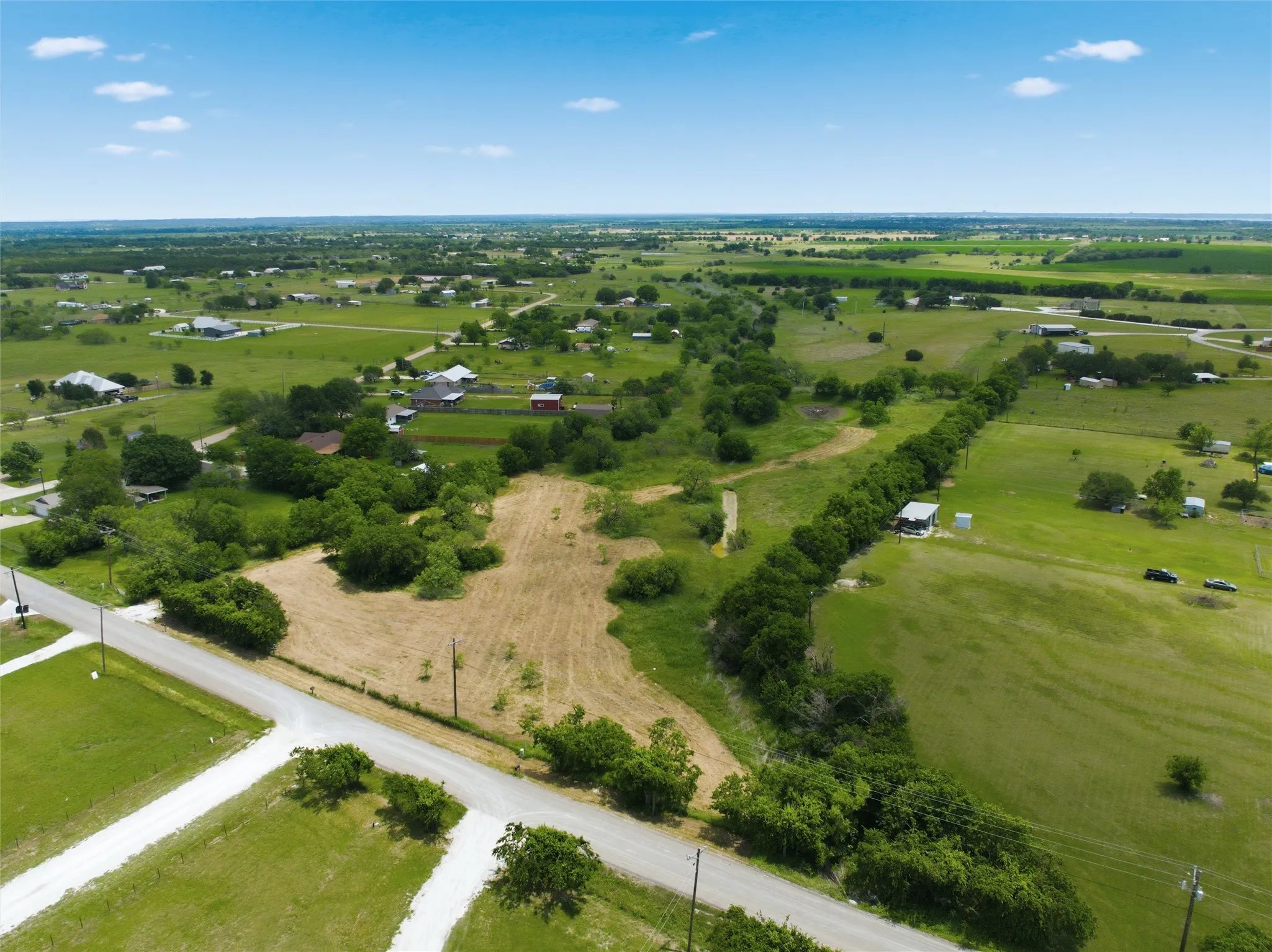 Expansive acreage featuring a mix of open fields and mature trees