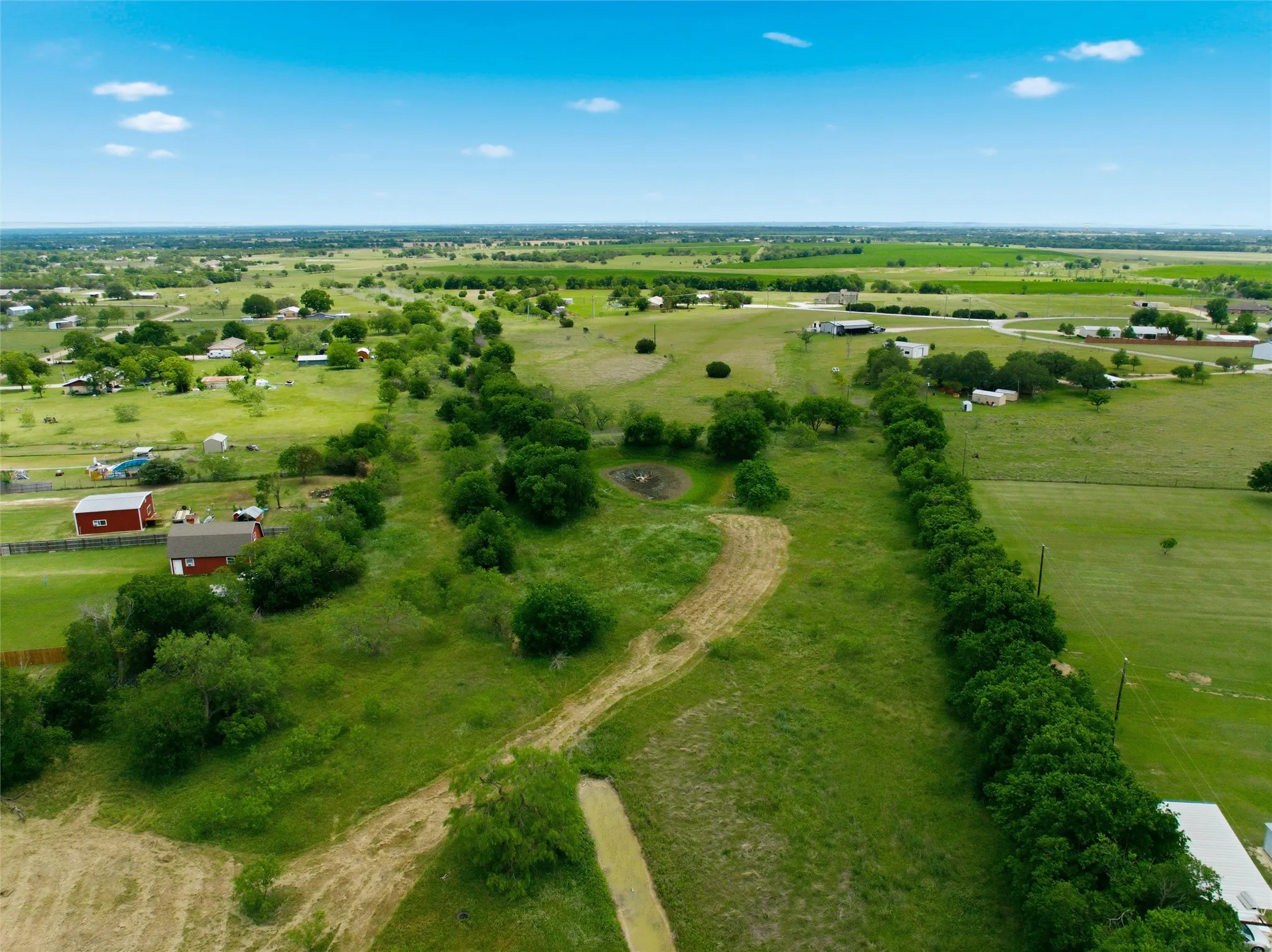 Expansive green acreage with numerous mature trees