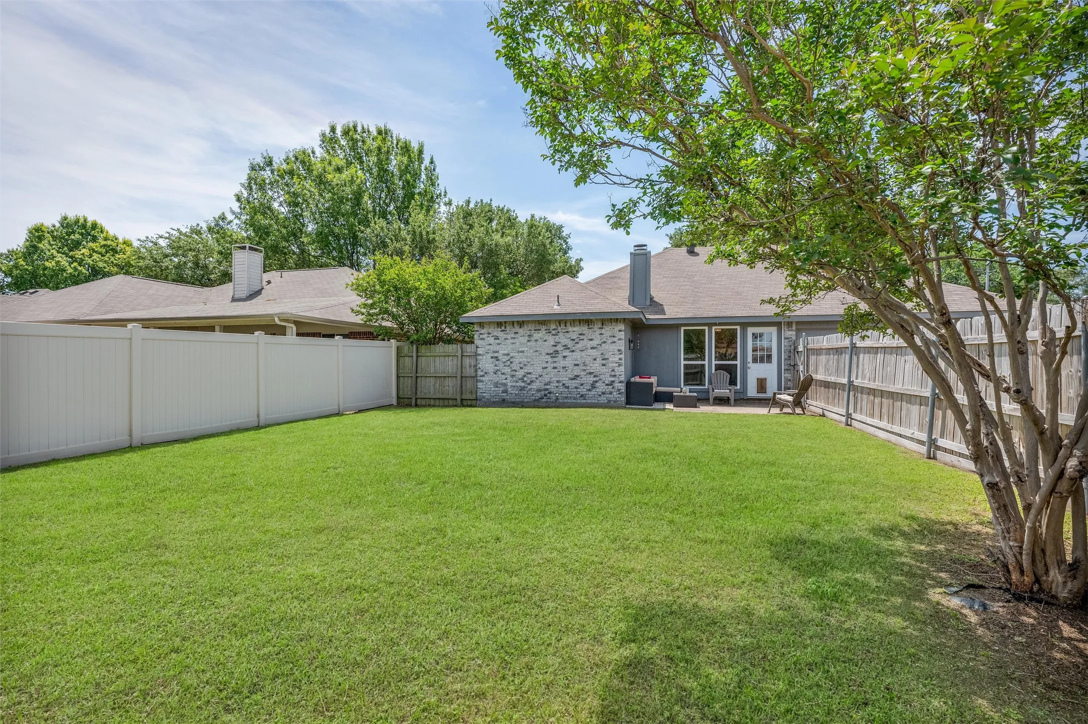 View of the back of the home, large backyard