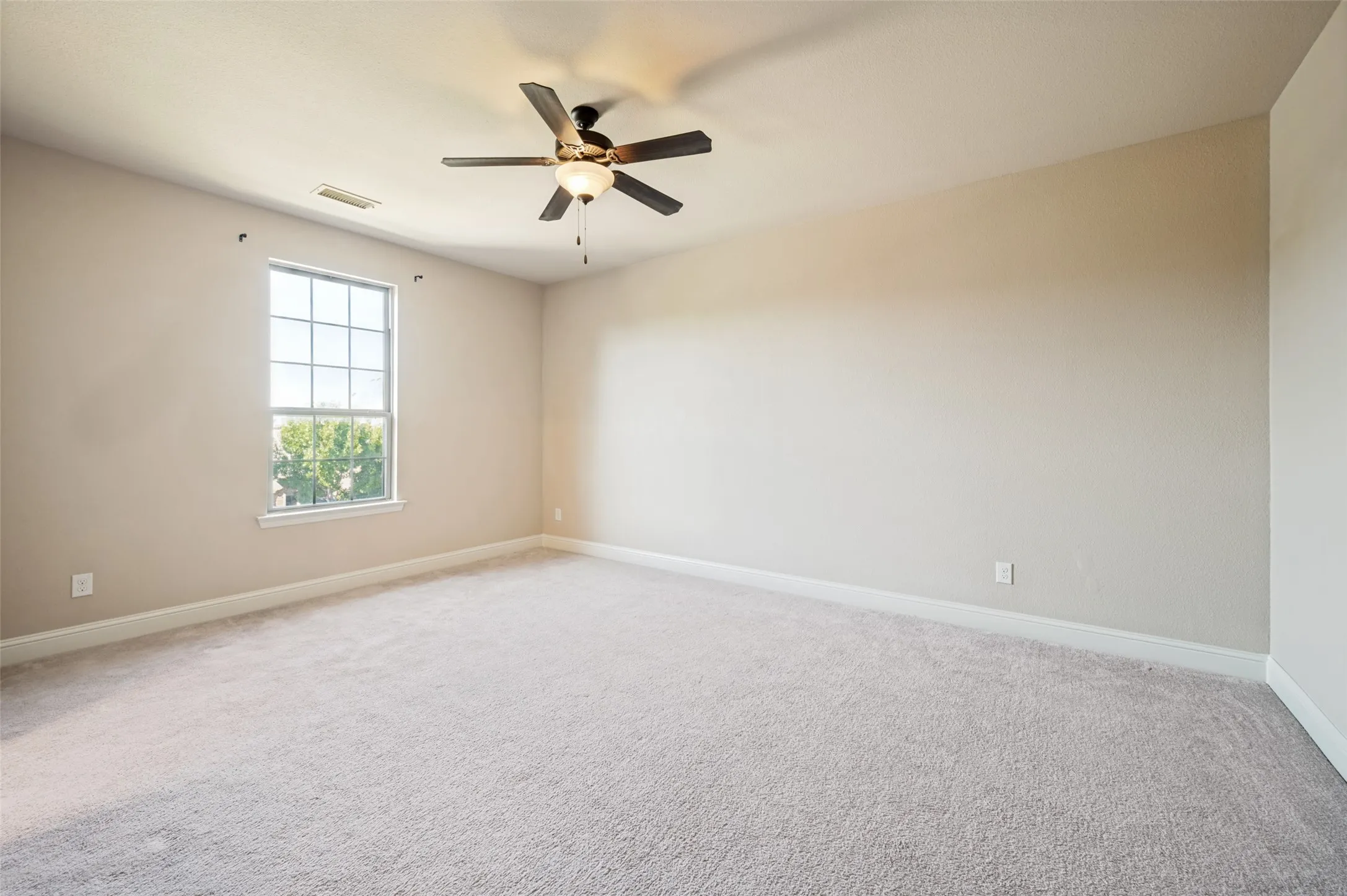 Spacious secondary bedroom with soaring vaulted ceilings, plush carpet, and abundant natural light, creating a bright and inviting retreat. Complete with a private ensuite bathroom and walk-in closet, this well-appointed suite offers comfort, privacy, and flexibility for family members or overnight guests.