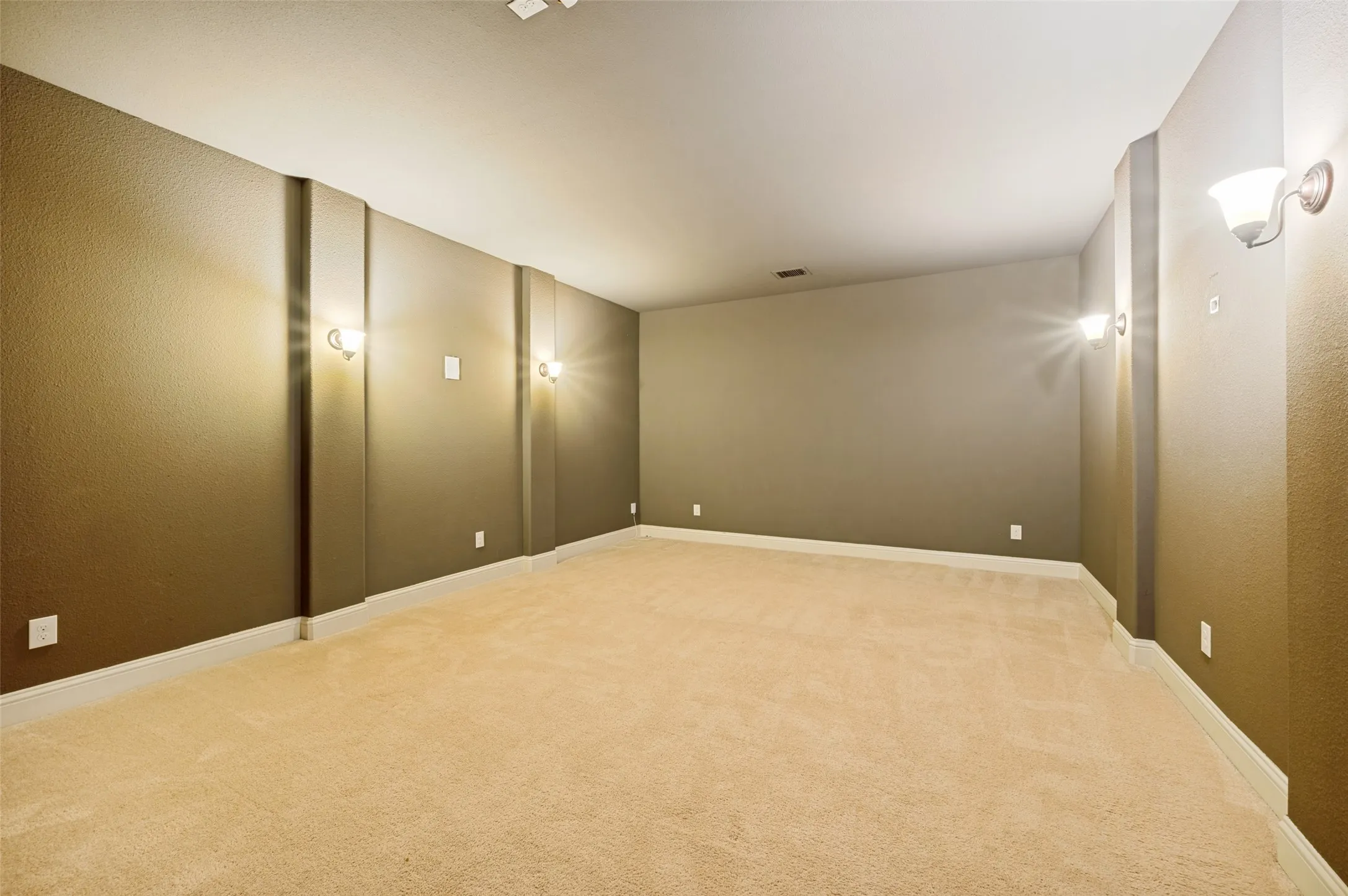 Dedicated media room designed for the ultimate movie night or game-day experience. This spacious, light-controlled retreat offers ample room for theater seating, a large screen, and surround sound, creating the perfect space for entertainment at home.