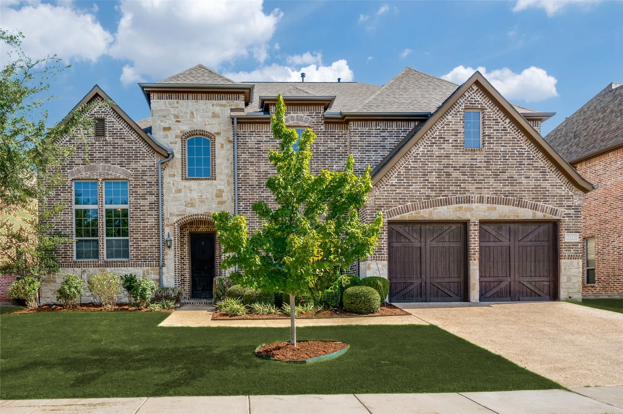 Stately brick and stone elevation, manicured landscaping, and an elegant arched entry create a striking first impression for this 5-bedroom, 4-bath home in The Tribute. With over 4,700 square feet and timeless architectural appeal, this residence offers luxury living in one of North Dallas’ premier golf and lakeside communities.