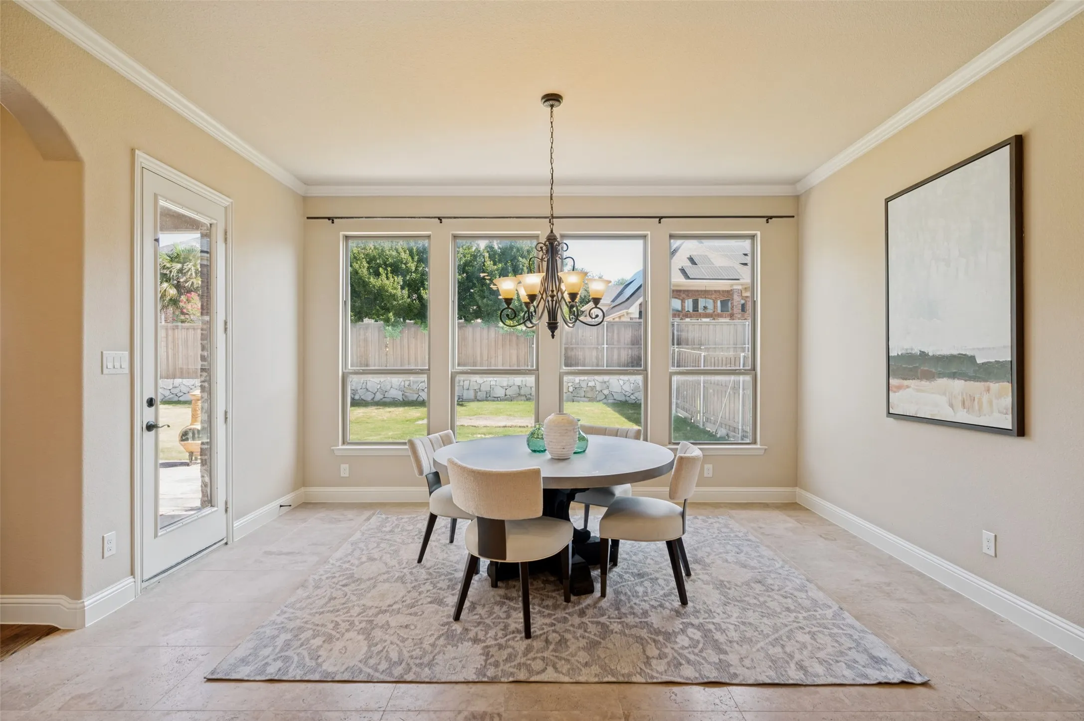 Breakfast nook with abundant natural light, perfectly positioned just off the kitchen and overlooking the backyard. Large windows create a bright, inviting space for everyday dining while offering peaceful backyard views and easy access to the covered patio for seamless indoor-outdoor living.