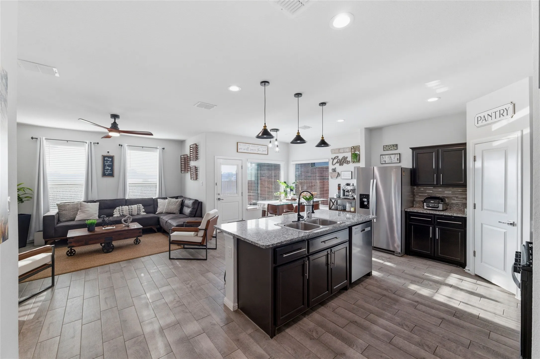 Open concept living area featuring wood-finish tile flooring throughout