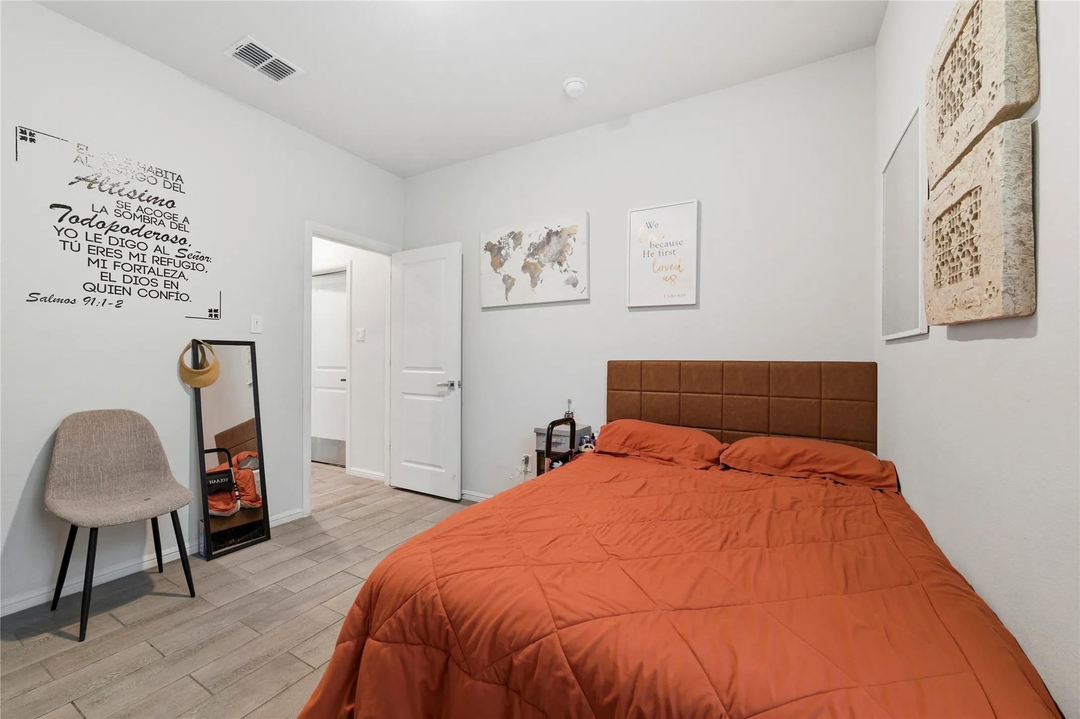 Bedroom featuring light-toned walls and wood-finish flooring