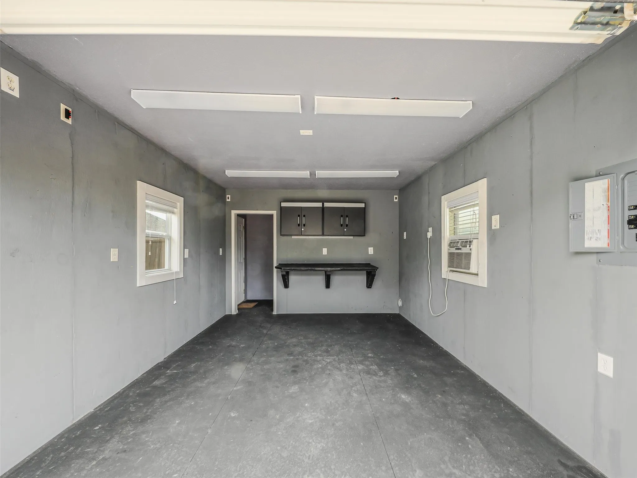 Workshop with AC / could house an extra car or motorcycle.  DOUBLE gates on fence area for ENTRY. Previous owner used as a WORKOUT / Exercise ROOM.