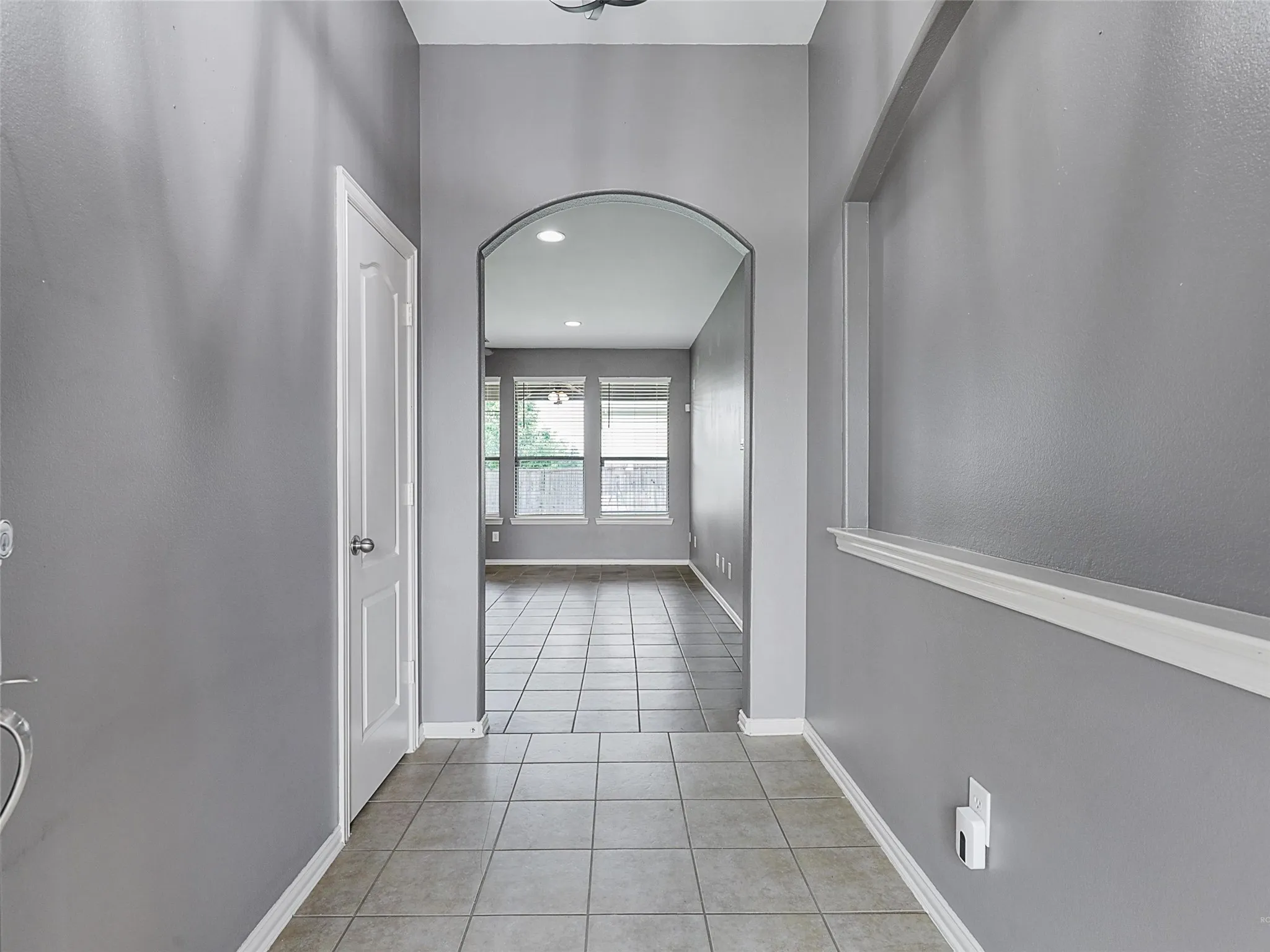 Arched Doorways, Tile and wood blinds throughout.