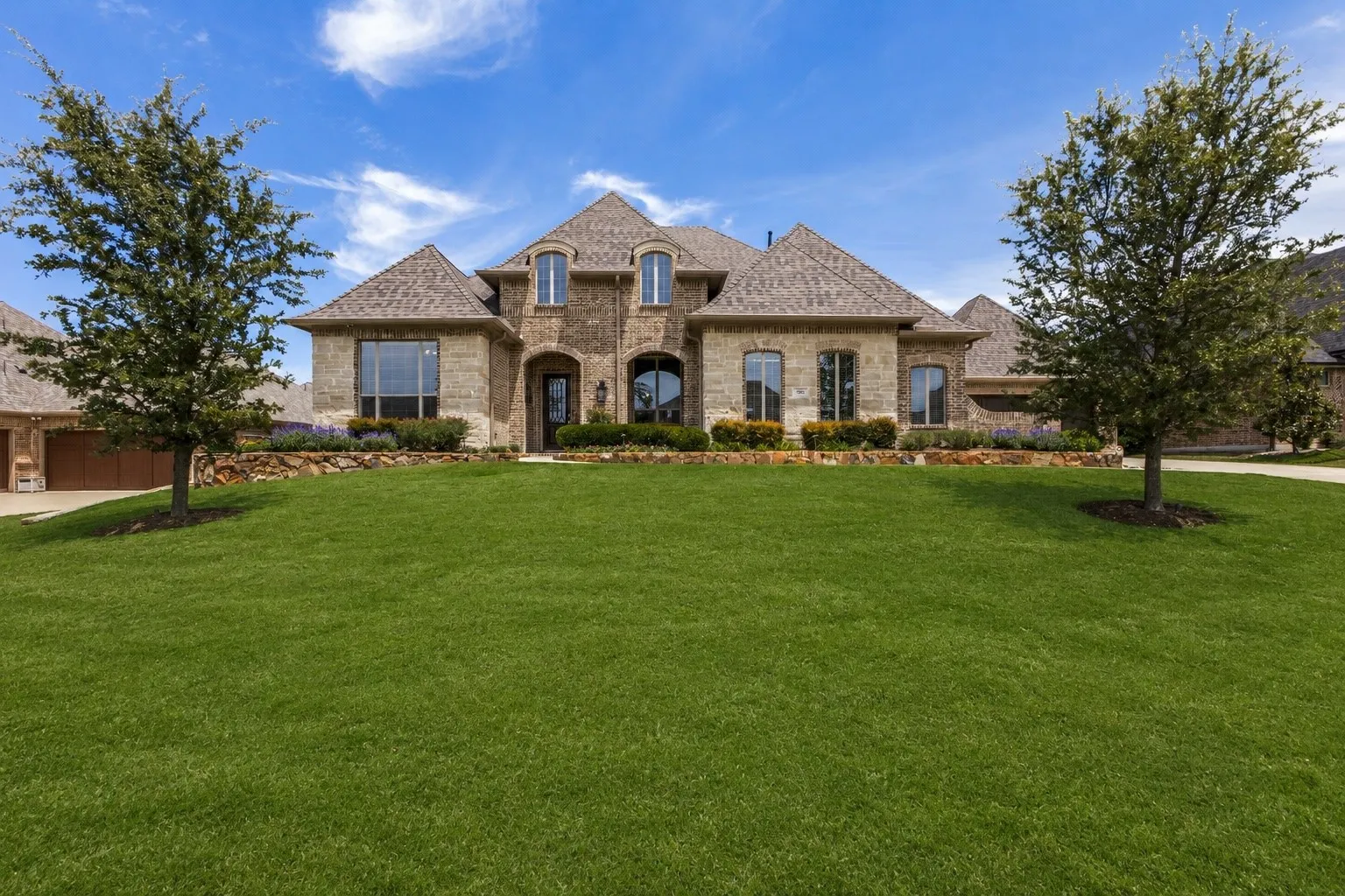 Spacious front yard and beautiful drive up with mature landscaping.
