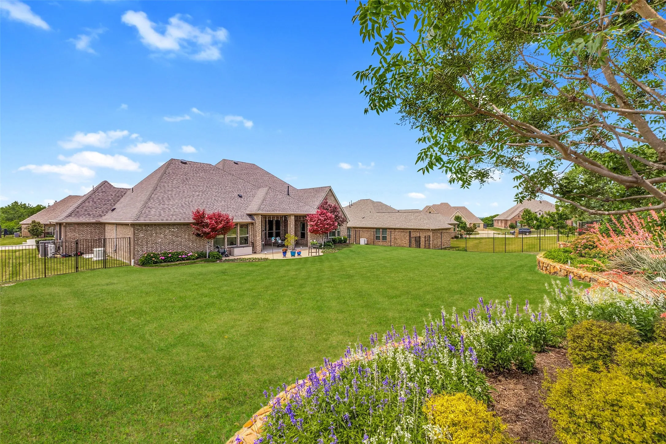 Beautiful stone lined flower beds with established landscaping.