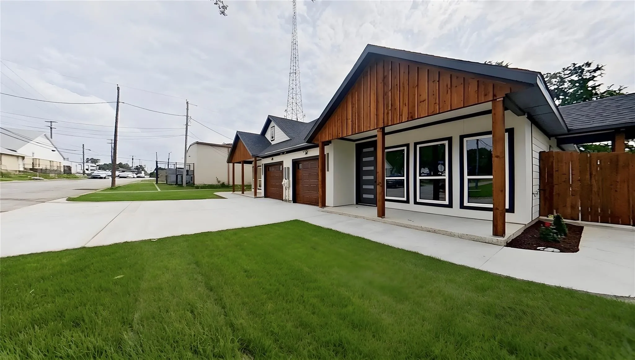 Contemporary architectural style with a gabled roofline and exposed wood siding accents