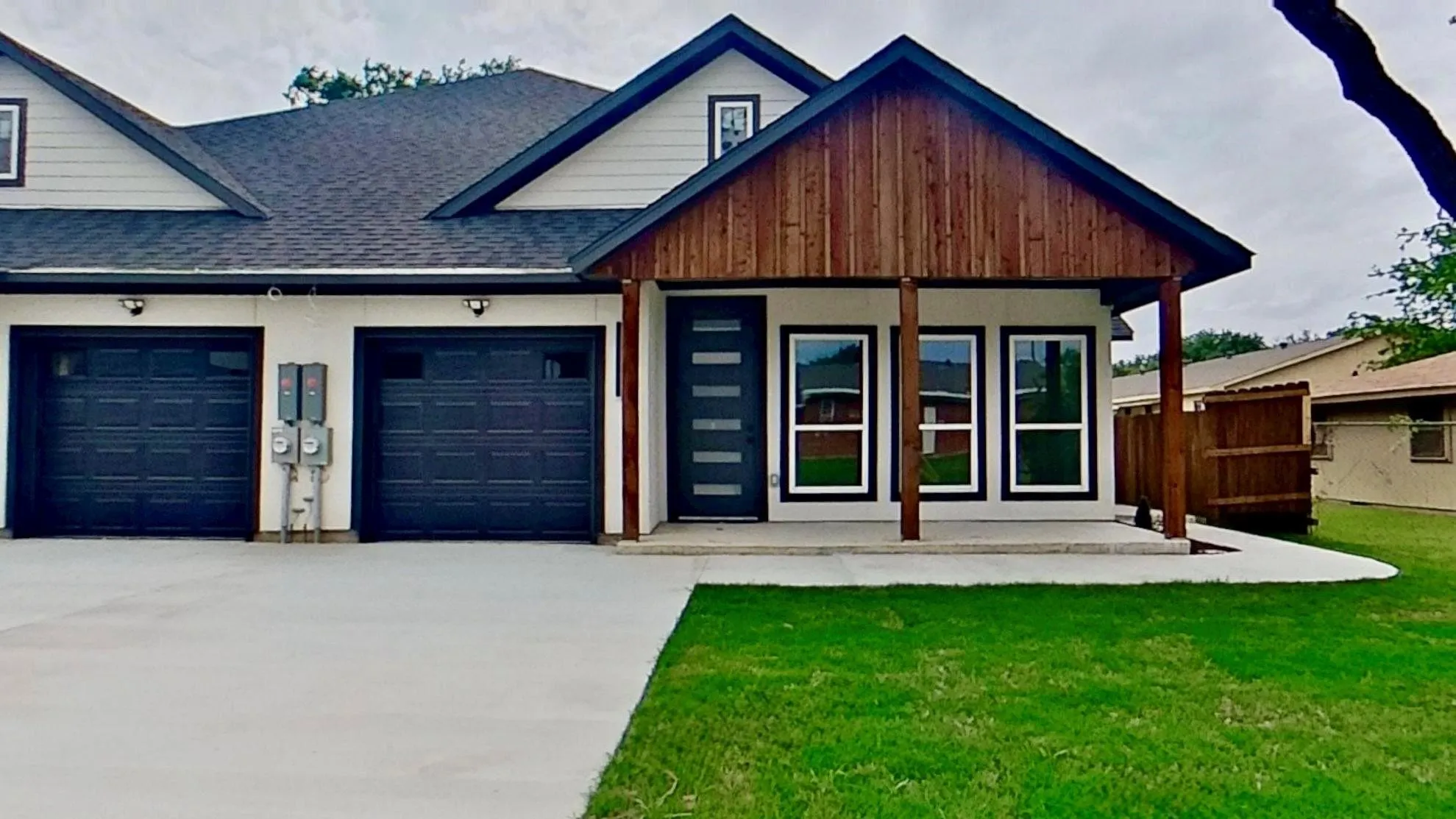 Contemporary exterior featuring a covered entry porch with wood-finish accents