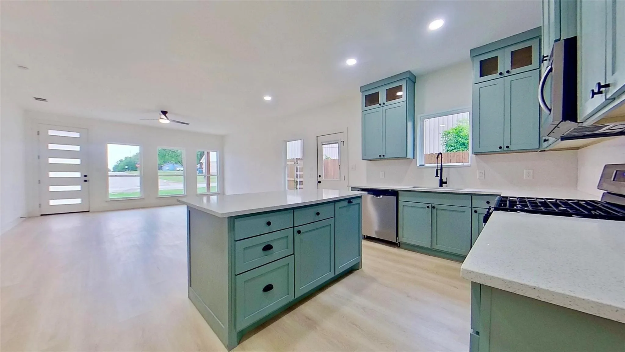 Open-concept living space featuring light wood-finish flooring throughout