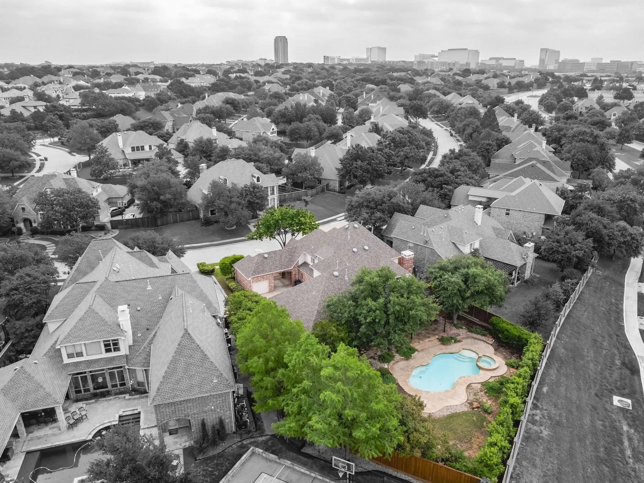 Aerial perspective highlighting the property's irregular-shaped swimming pool with an integrated spa