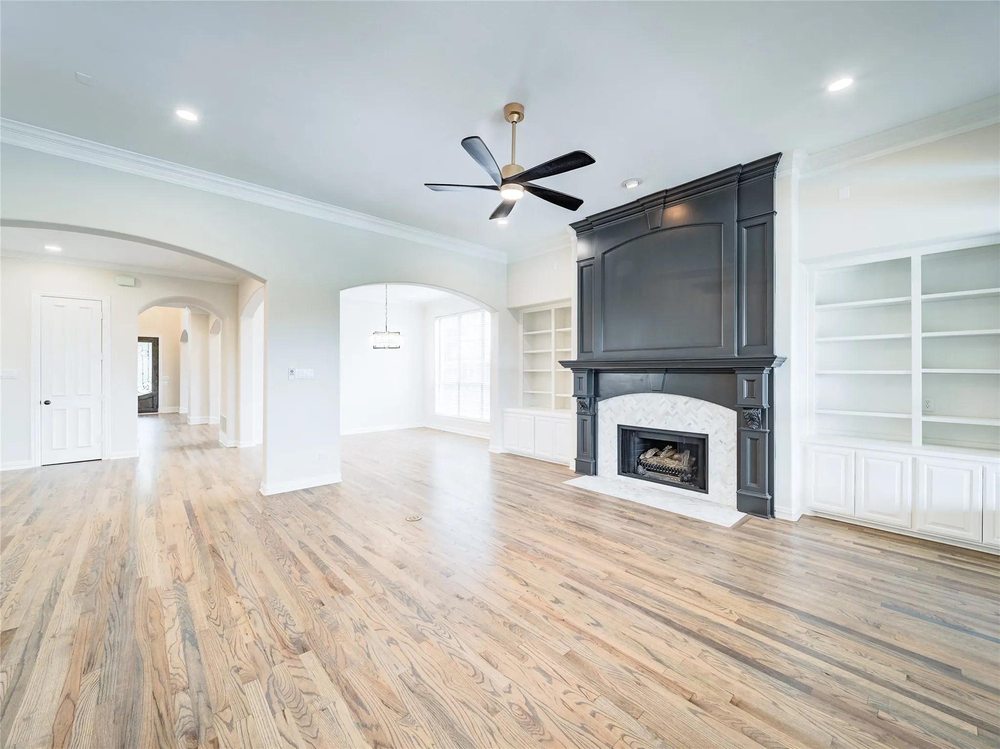 Living space featuring wood-finish flooring and recessed lighting