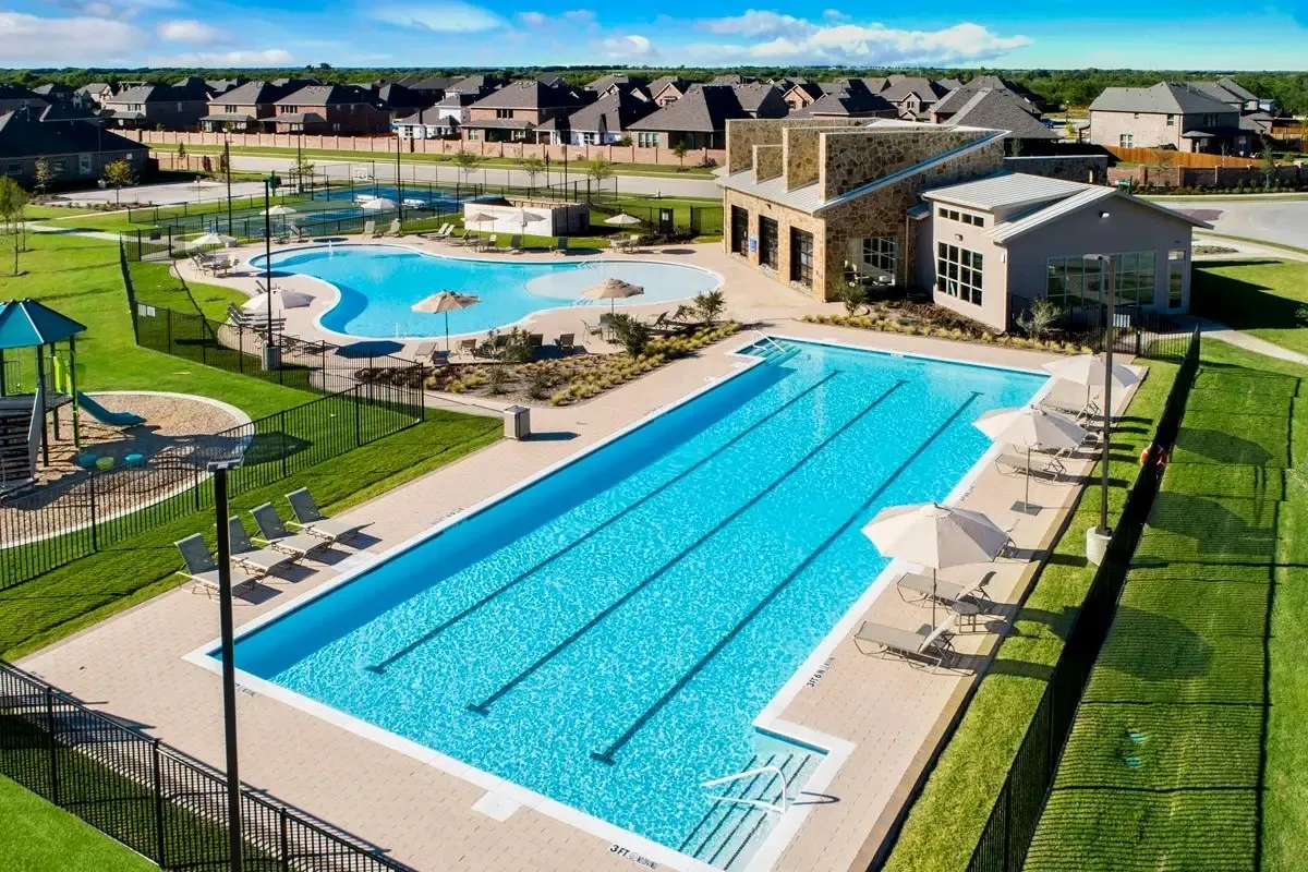Expansive community recreation area featuring a lap pool, a freeform pool, and a dedicated play structure