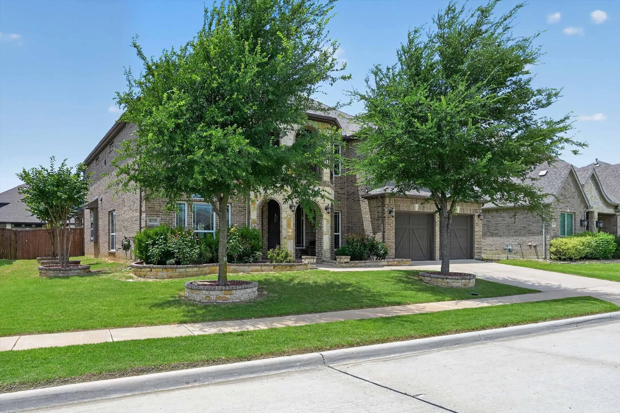 Brick exterior featuring stone accents and an arched entryway