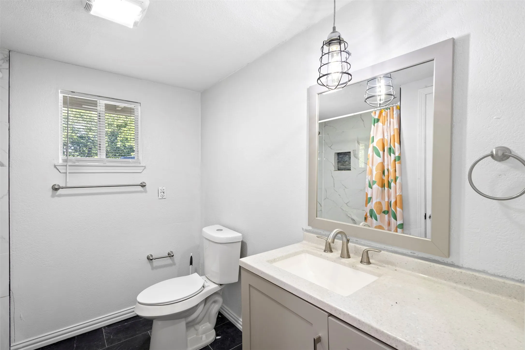 Bathroom has contemporary lighting and fixtures and natural light as well!
