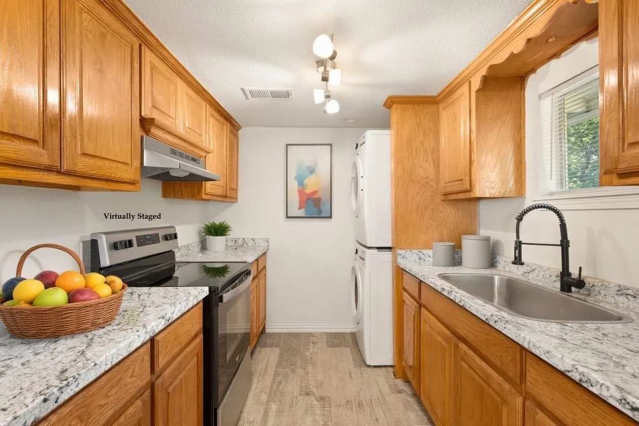 Efficient kitchen with ample cabinetry and functional layout.  Adjacent to area perfect for bistro dining!