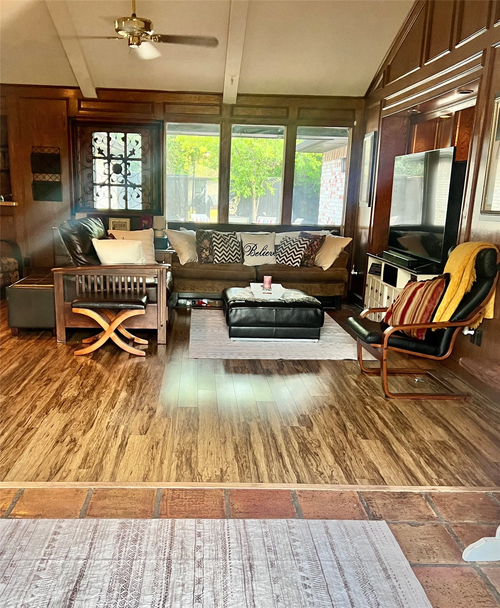 Living room with views of the back patio and yard