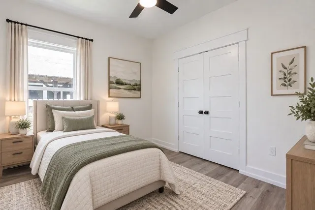 Virtual staging - Wood-finish flooring, white paneled closet doors, single window with trim, and a ceiling fan with light fixture