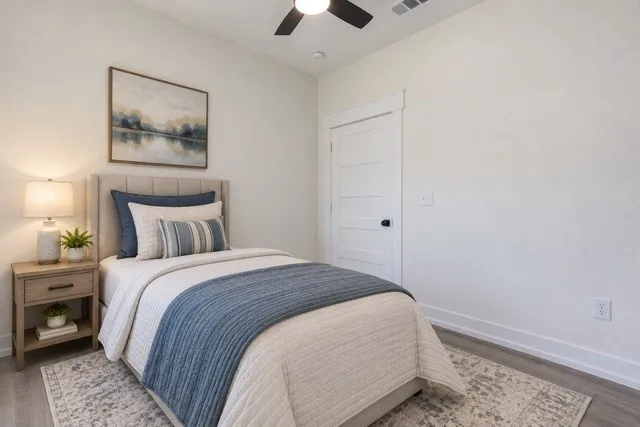 Virtual staging - Wood-finish flooring, crisp white walls, and a multi-paneled door with dark hardware