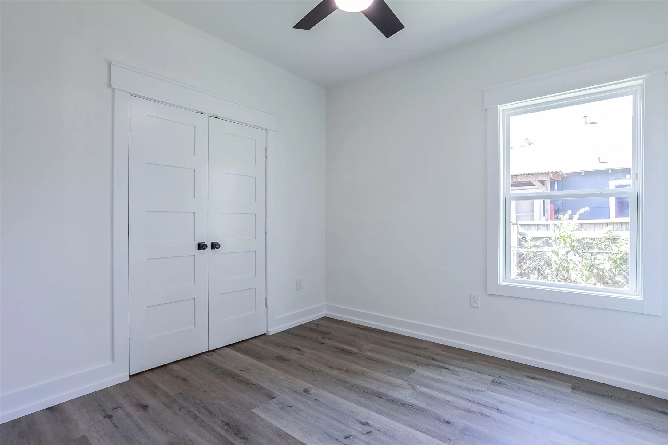 Bright interior featuring wood-finish flooring and a ceiling fan