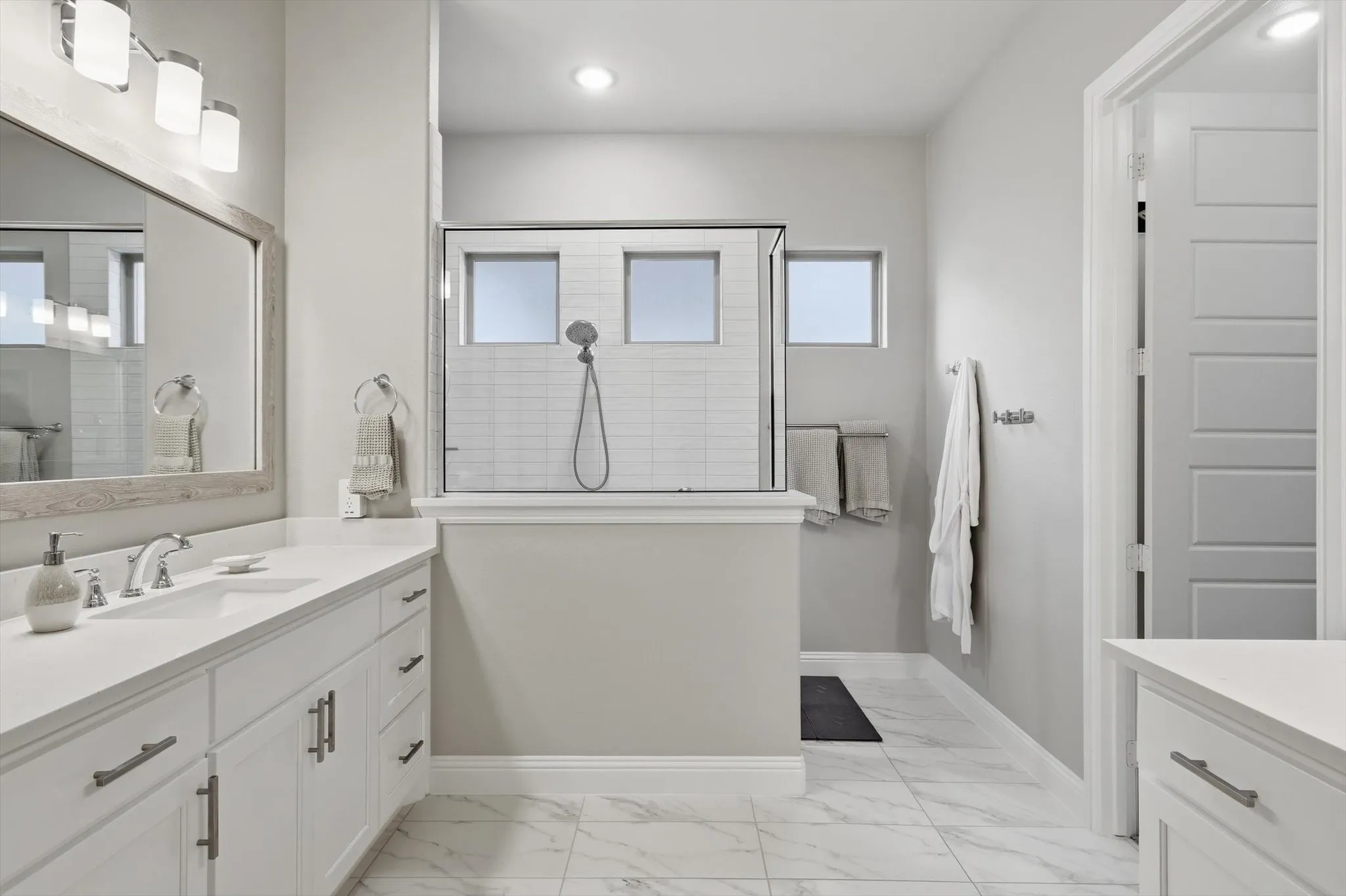 Generous walk-in shower, separate vanities, and 2 oversized walk-in closets.