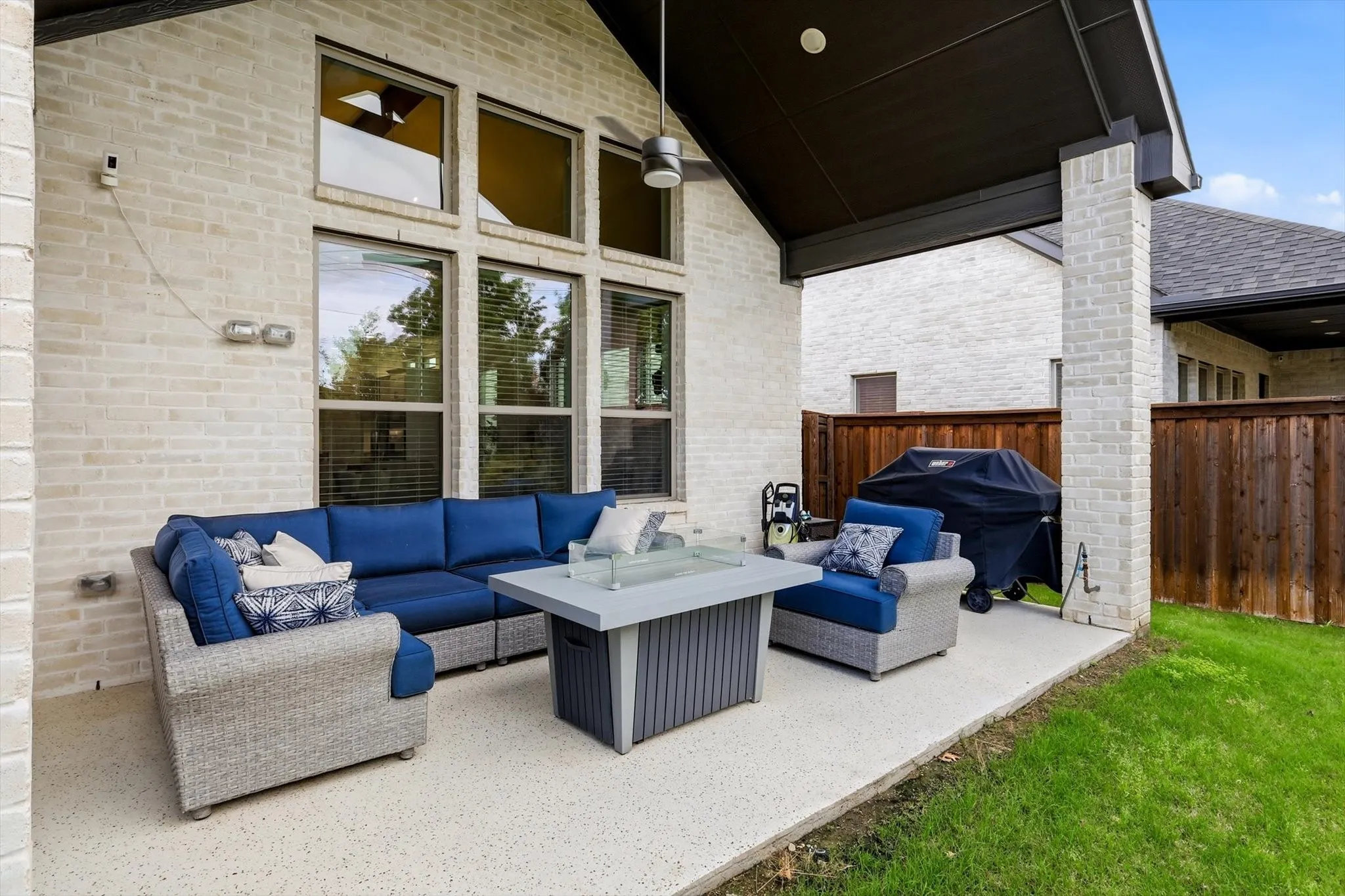 Private backyard oasis, complete with an epoxy-coated covered patio, gas stub for grilling, and beautifully designed custom landscaping.
