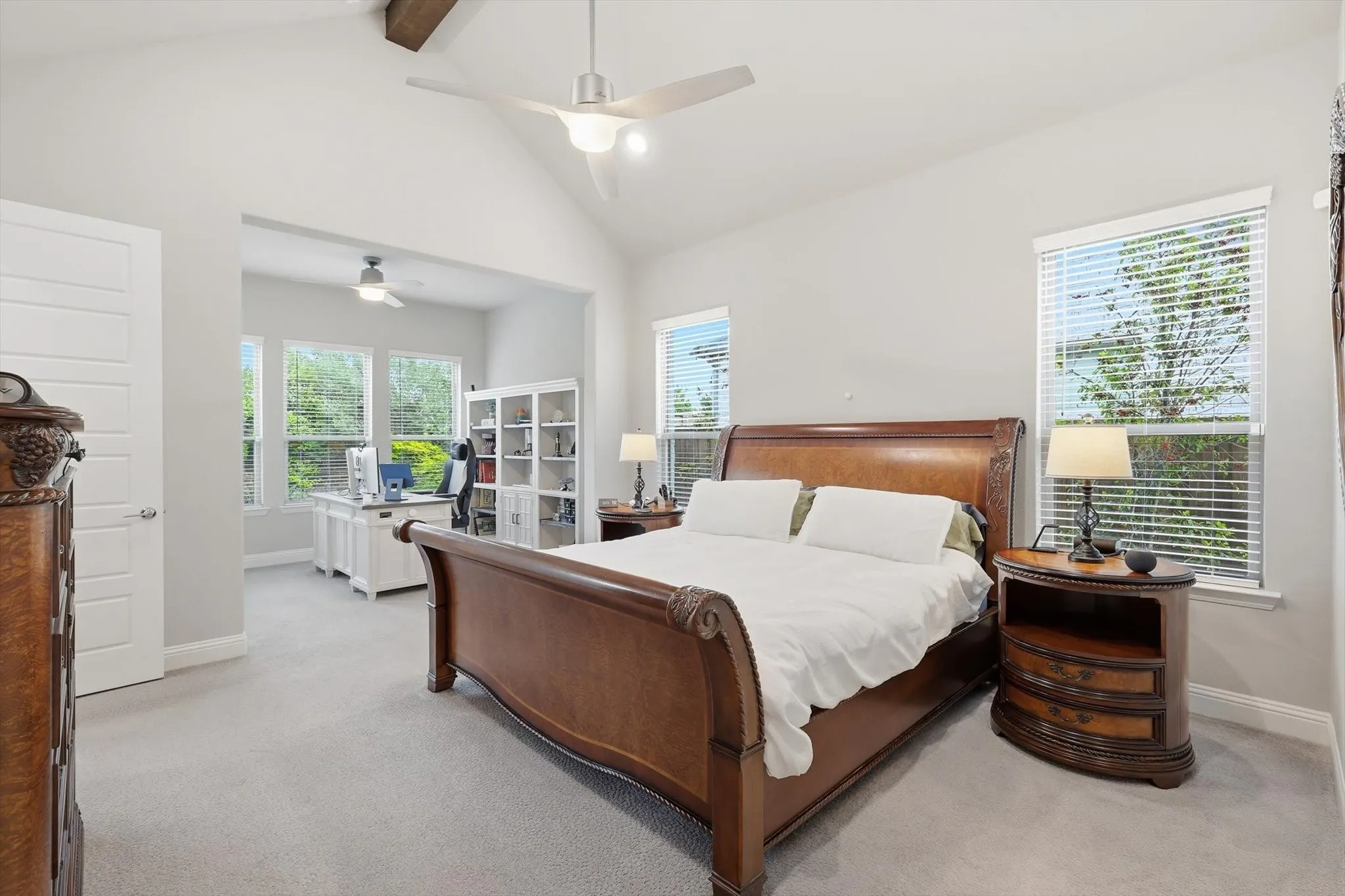 Vaulted ceilings accented by a wood beam and an extended sitting area, perfect for a home gym or reading nook!