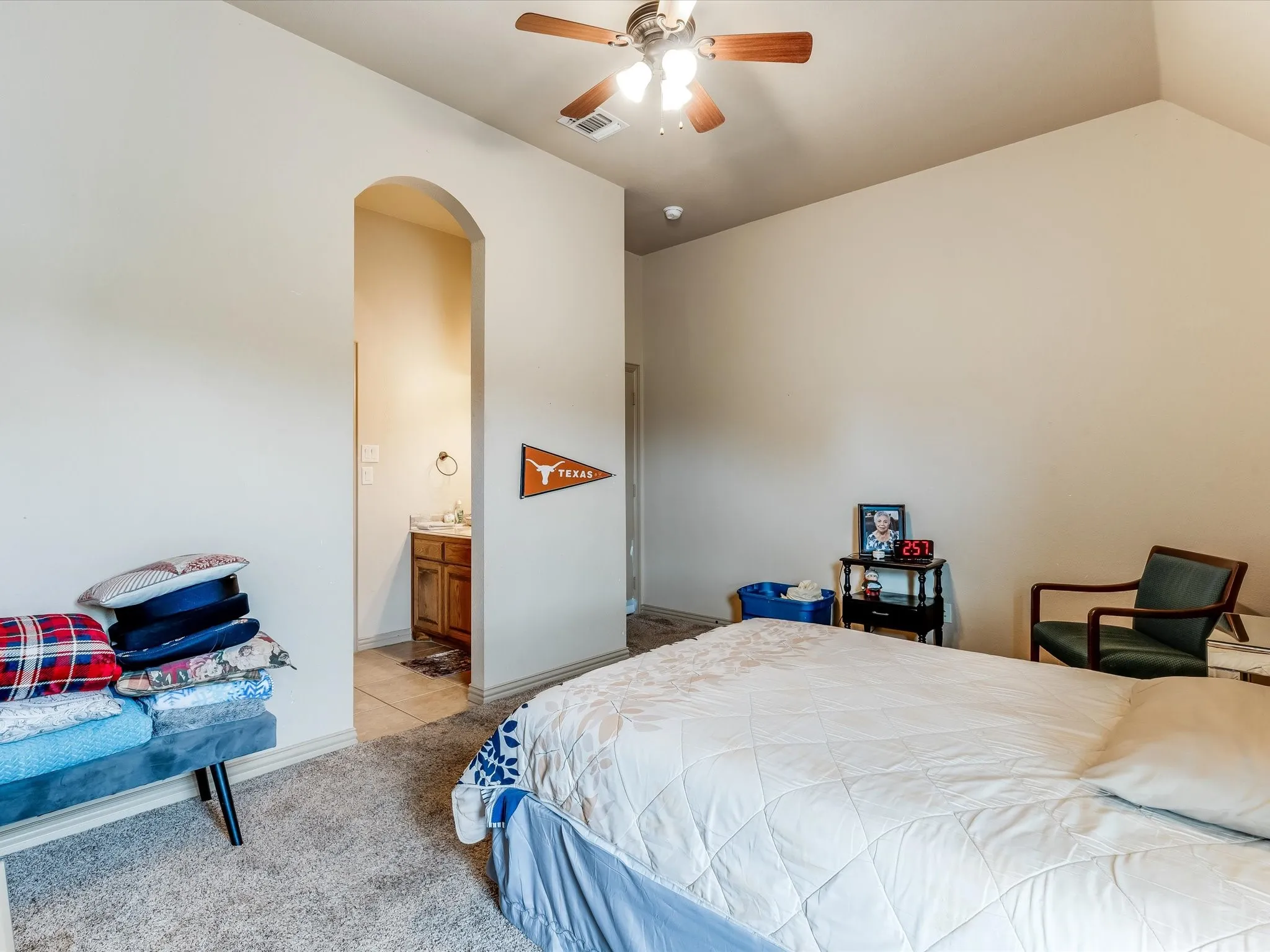 Room featuring vaulted ceilings, carpet flooring, and a ceiling fan with integrated lighting